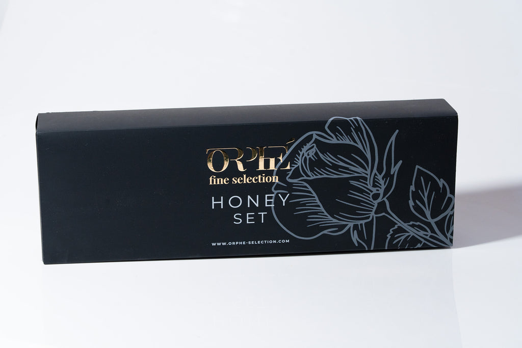 "Black box packaging with floral artwork and 'ORPE fine selection' branding on a white background, linked to honey purple and lavender syrup