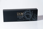 "Black box packaging with floral artwork and 'ORPE fine selection' branding on a white background, linked to honey purple and lavender syrup