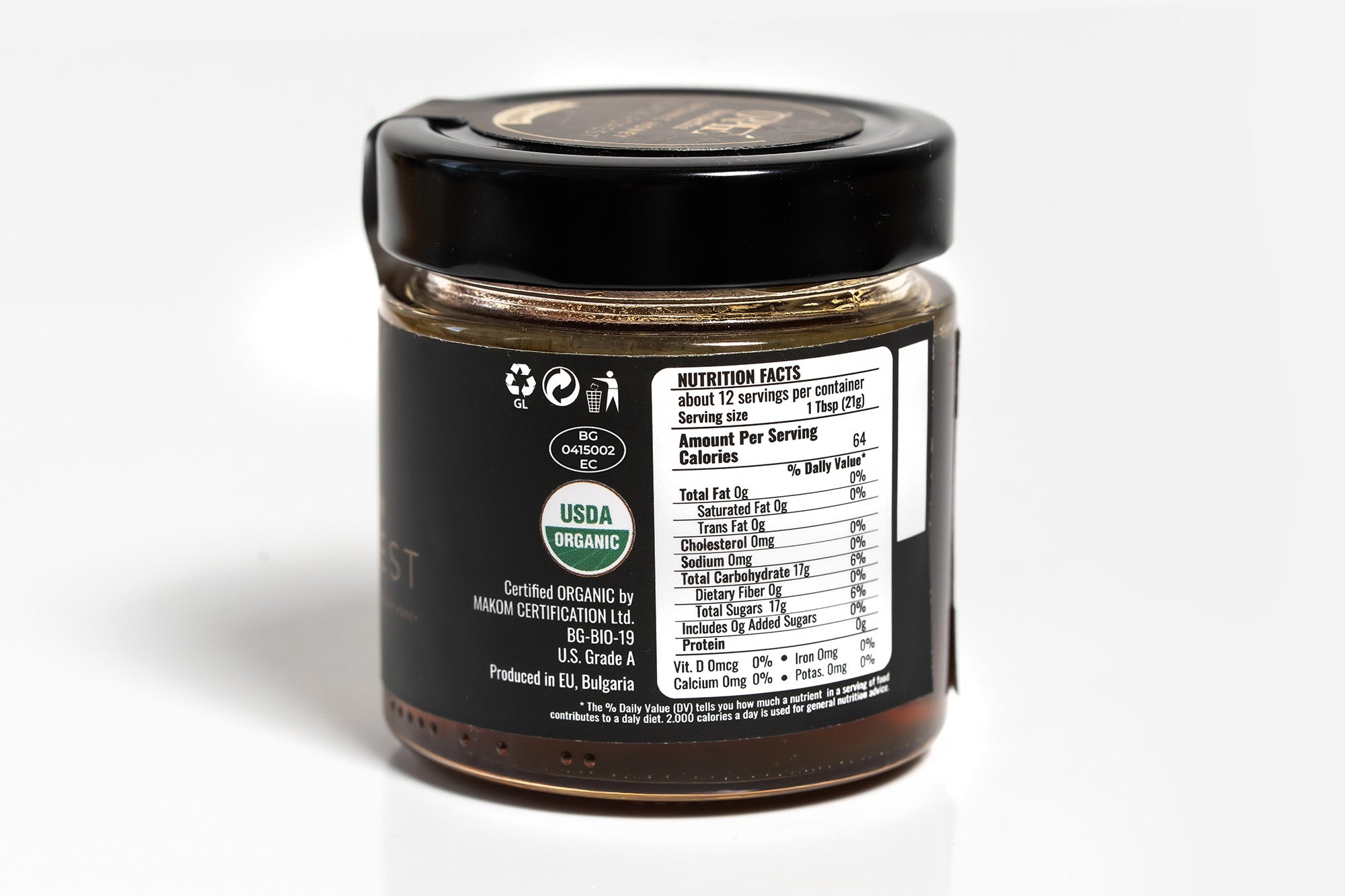 Clear glass jar topped with a black lid, featuring a prominent organic label with natural design elements. The jar is set against a clean white background, emphasizing its eco-friendly and organic qualities.