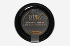 Orpe brand organic honey in a clear container with a sleek black lid, filled with rich golden honey. The container features a clean, eco-friendly label and is photographed against a white background for a crisp, professional look.