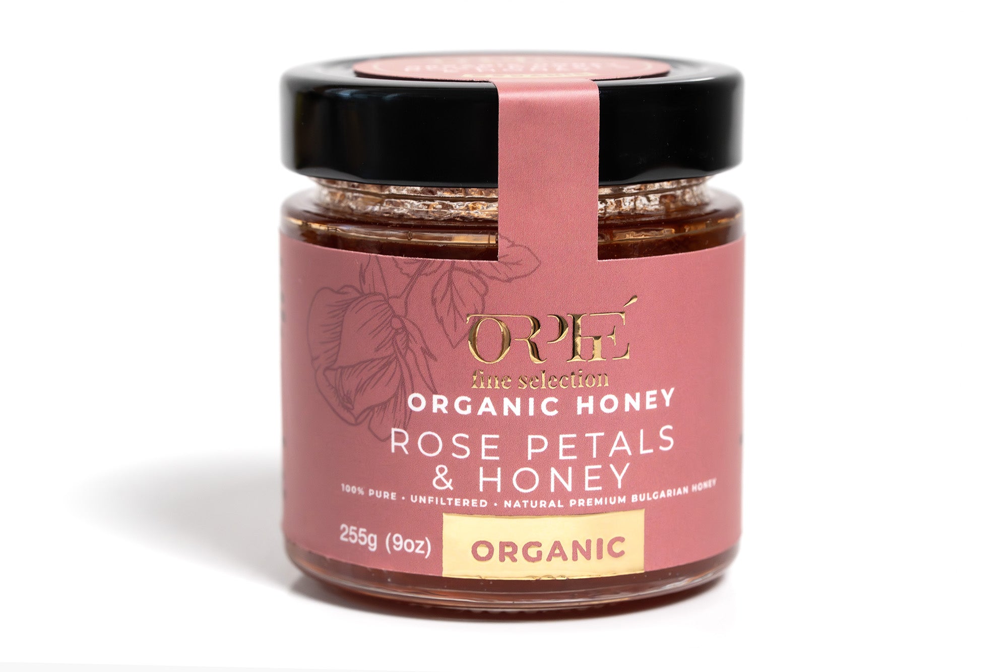 Two glass jars of organic honey placed inside a sleek black gift box. One jar is labeled 'Black Forest' and the other 'Lavender,' both featuring elegant labels. The set includes a gold spoon resting inside the box, creating a luxurious and artisanal presentation.