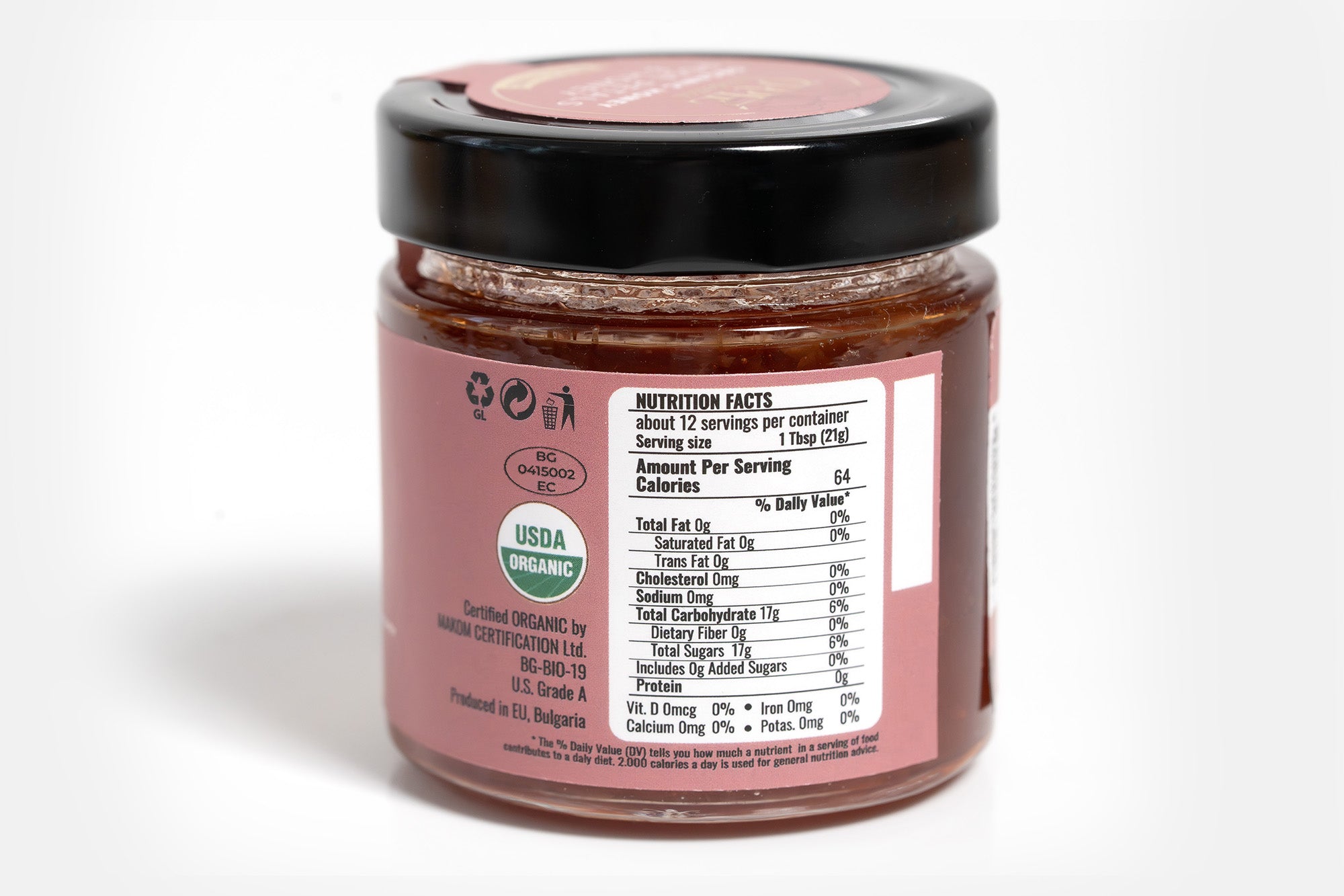 Clear glass jar containing organic spread with a visible front label displaying branding and product details. The jar is set against a clean white background, emphasizing the natural and wholesome qualities of the spread.