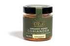 Orphe  jar of organic honey infused with coriander flavor, showcasing a rich amber color. The jar features a label indicating the coriander flavor and organic certification, set against a clean white background to highlight the product’s natural and artisanal qualities.