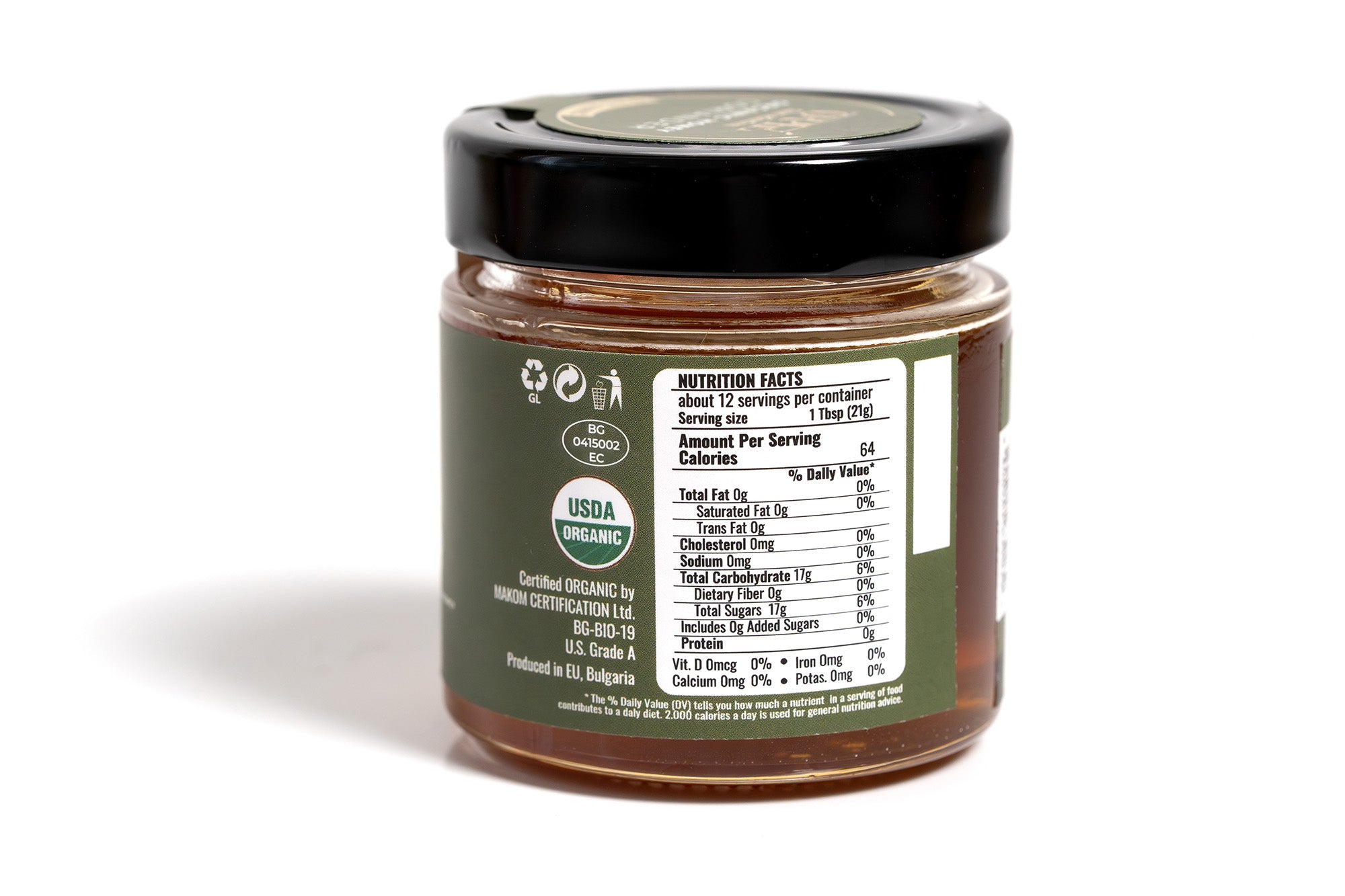 Clear glass jar containing an organic product, featuring a green label with eco-friendly design elements. The jar is set against a clean white background, emphasizing the natural and wholesome quality of the product.