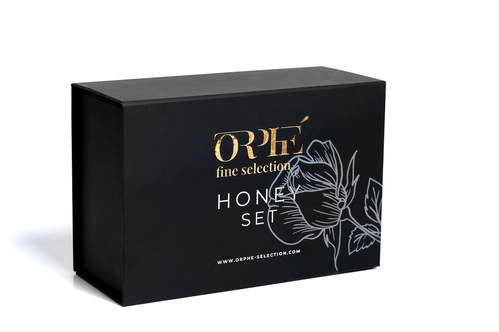 Black box with 'Orphe' branding and honey set design on a white background