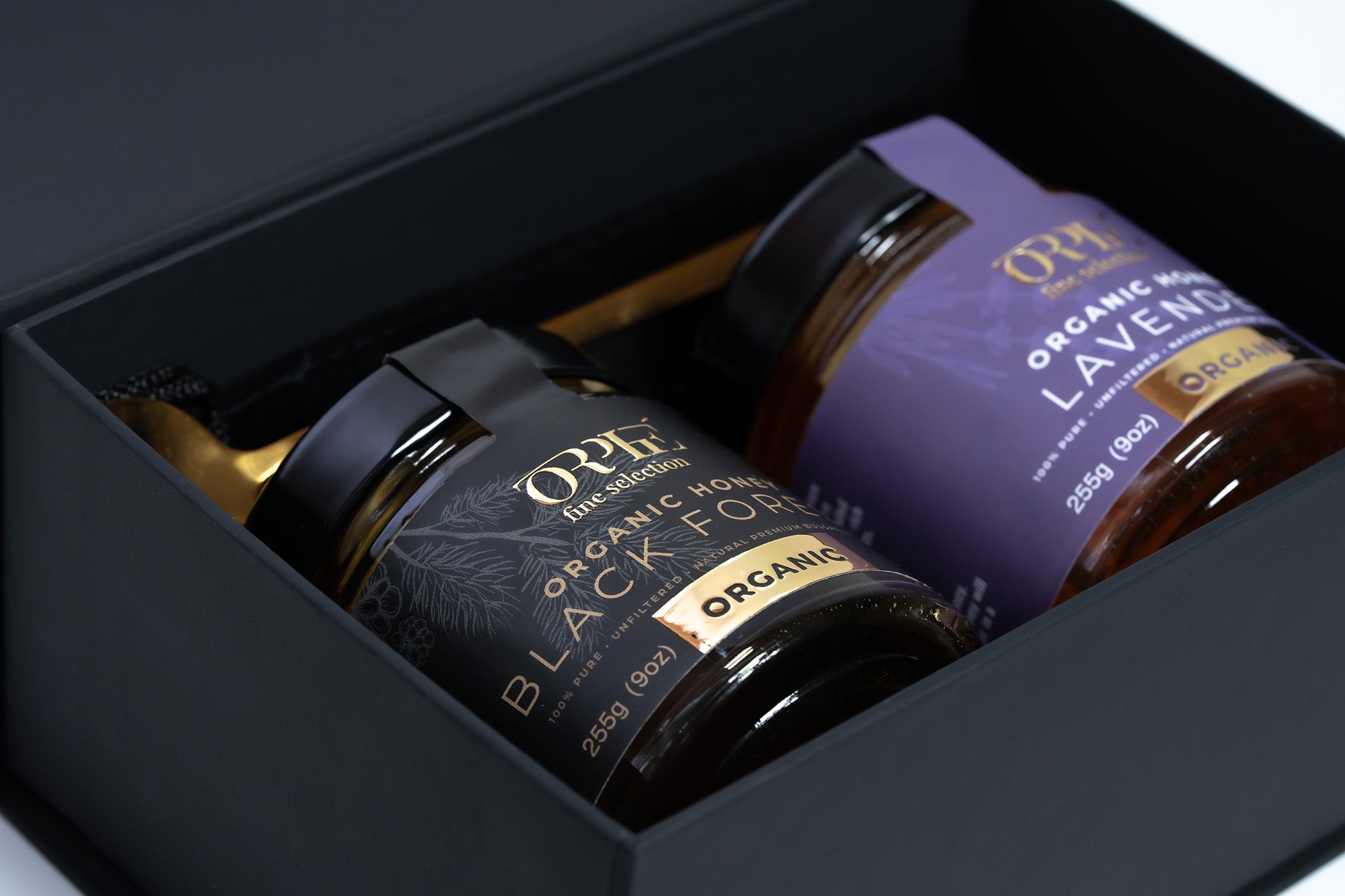 Two jars of ORPHE Organic Honey in a premium honey gift packaging.